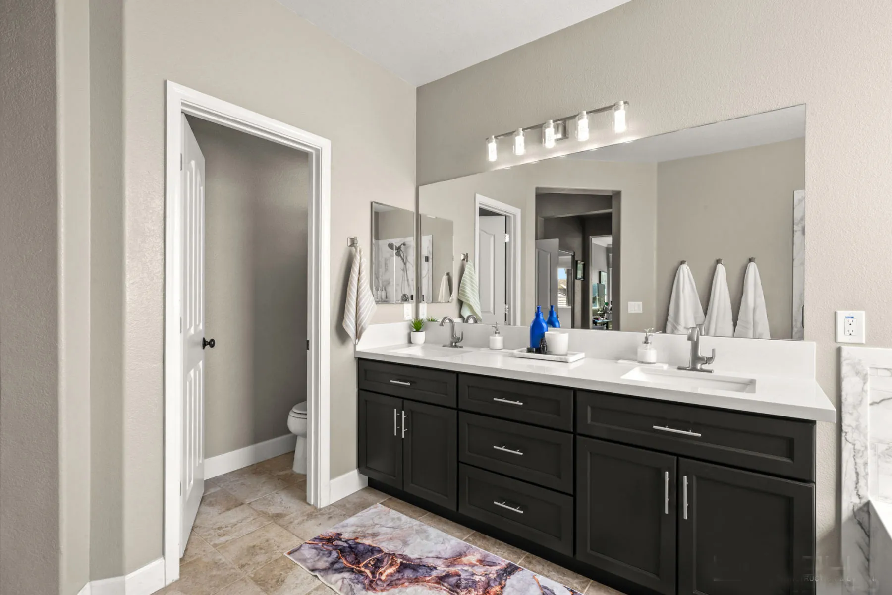 Wide view of the black double vanity and colorful runner