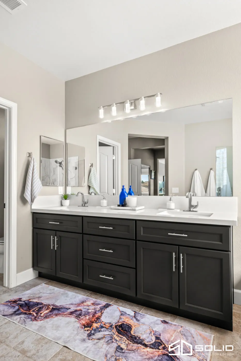 Portrait view of the black double vanity and patterned runner