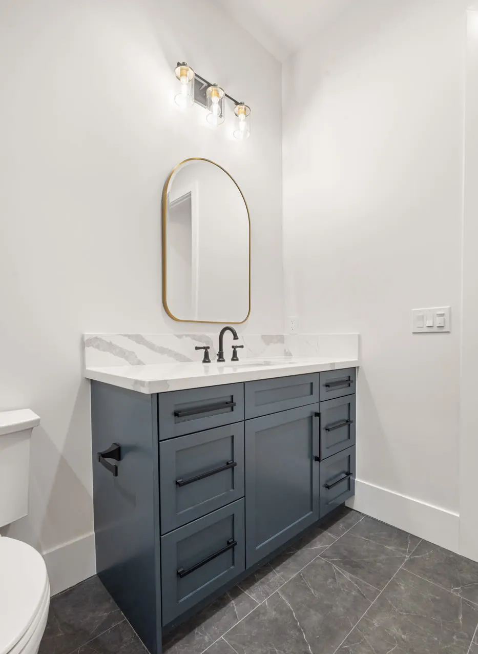 Portrait view of the blue vanity and arched mirror