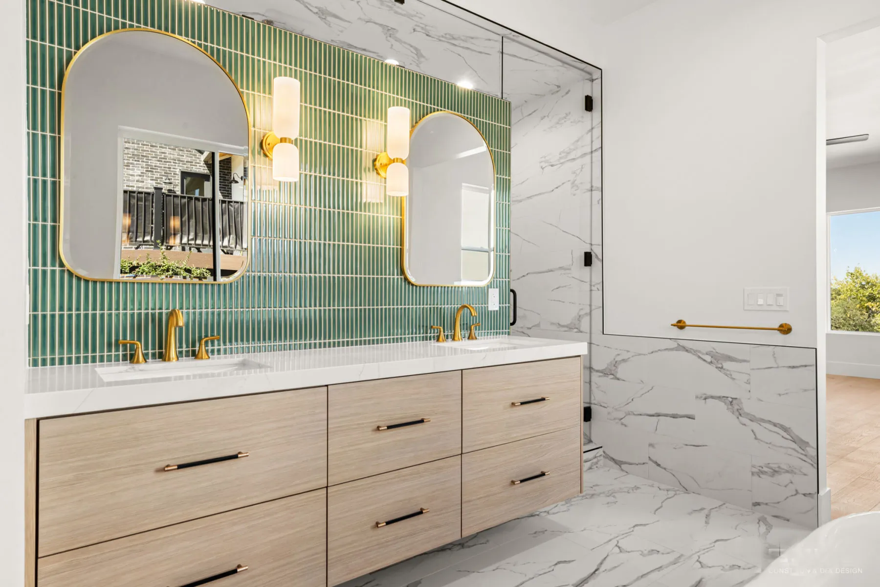 Oak double vanity with arched mirrors and a green vertical-tile backsplash