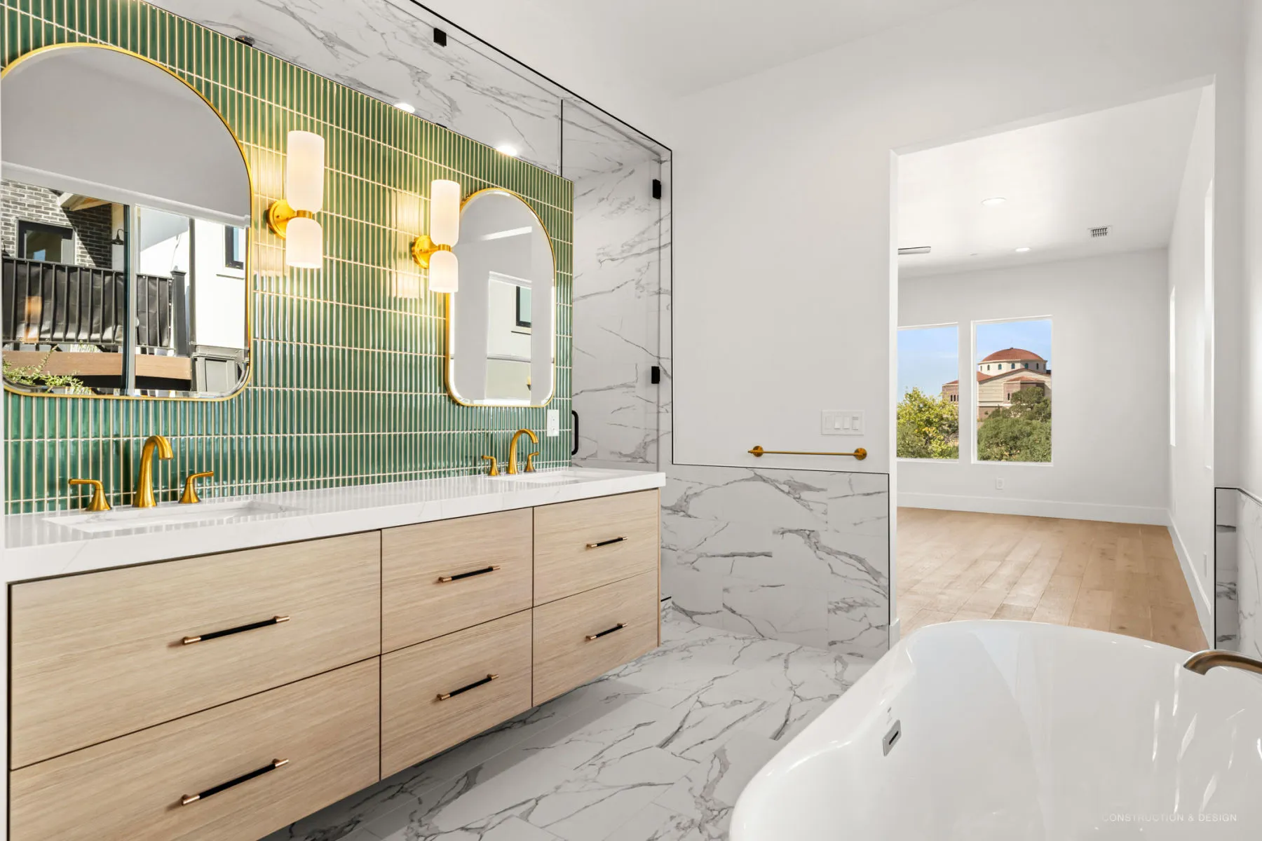 Angled view of the green-tile vanity wall and freestanding tub
