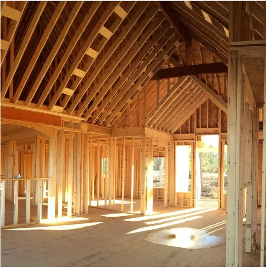 Sunlit interior with exposed wall and roof framing